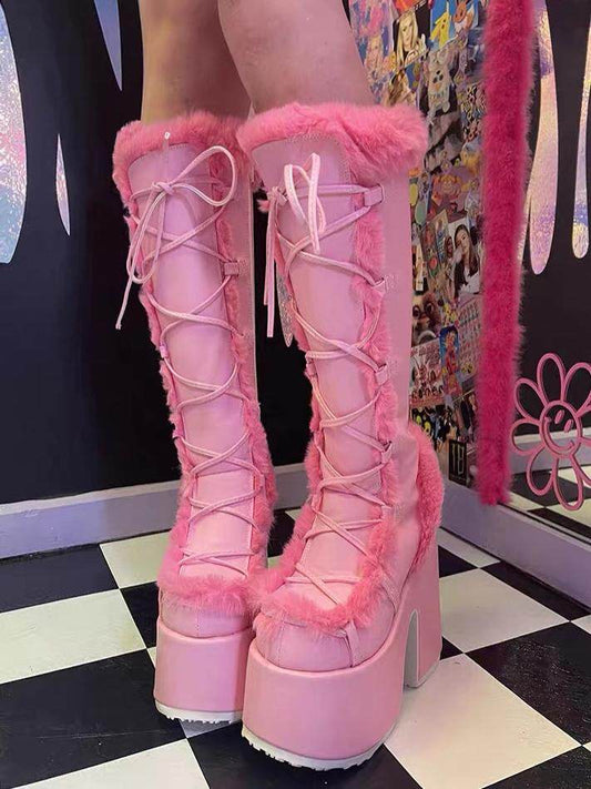 Pink platform ankle boots with lace-up front and thick faux-fur trim