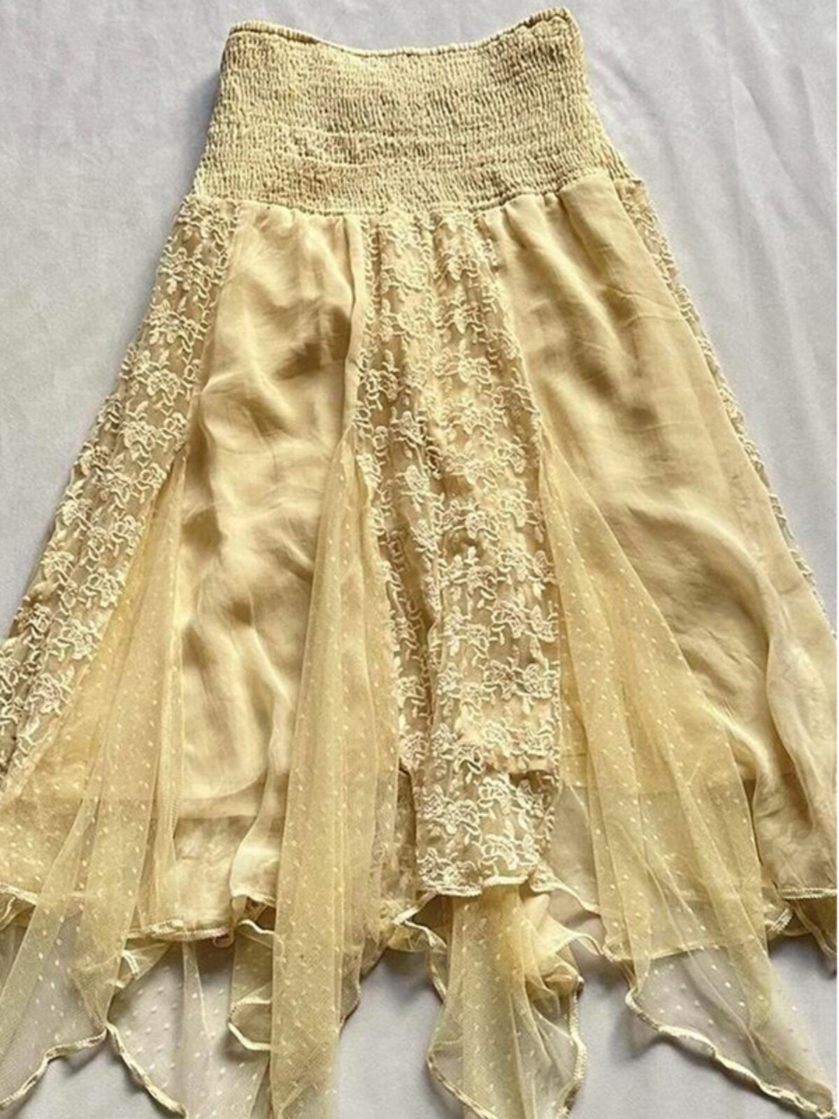 Yellow layered fairy-style skirt with lace patchwork, elastic waist, and uneven hem