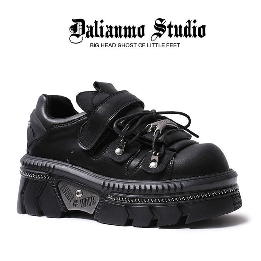 Black platform flats with double strap, lace-up closure, and thick tread sole