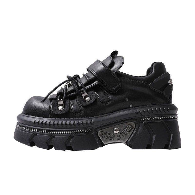 Black platform flats with lace-up, wide hook strap, and metal eyelets on lug sole