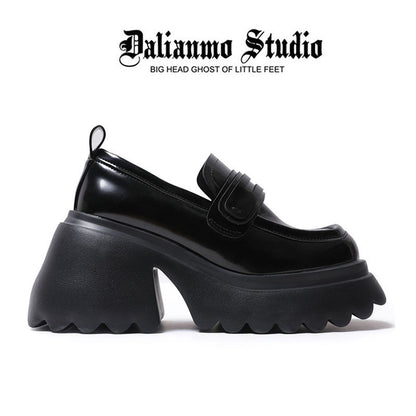 Black platform loafer with buckle strap detail and oversized sculpted lug sole