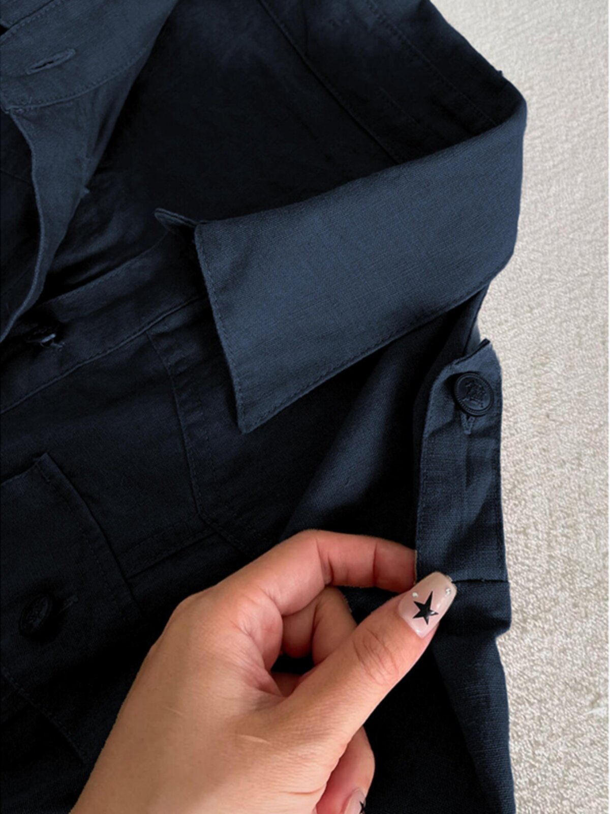 Dark blue shirt collar and button placket with decorative star-button detail