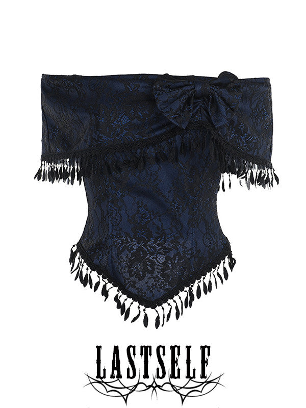 One-shoulder jacquard top with dark pattern, bow detail, and black tassel trim
