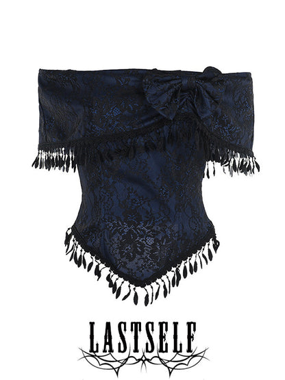 One-shoulder jacquard top with dark pattern, bow detail, and black tassel trim