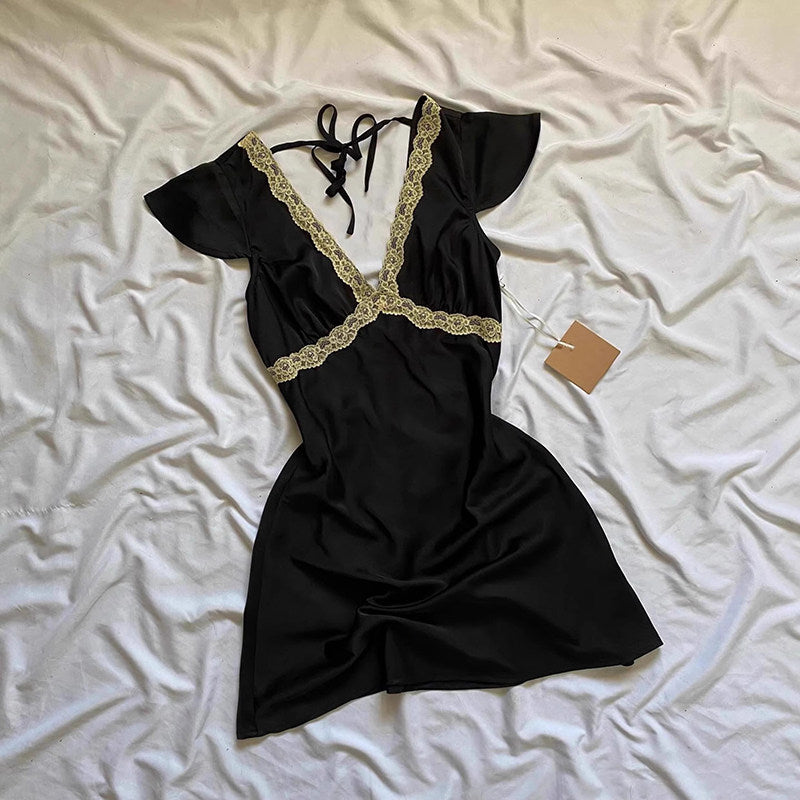 Black lace V-neck mini dress with puff sleeves, tie-back neckline, flared satin skirt.