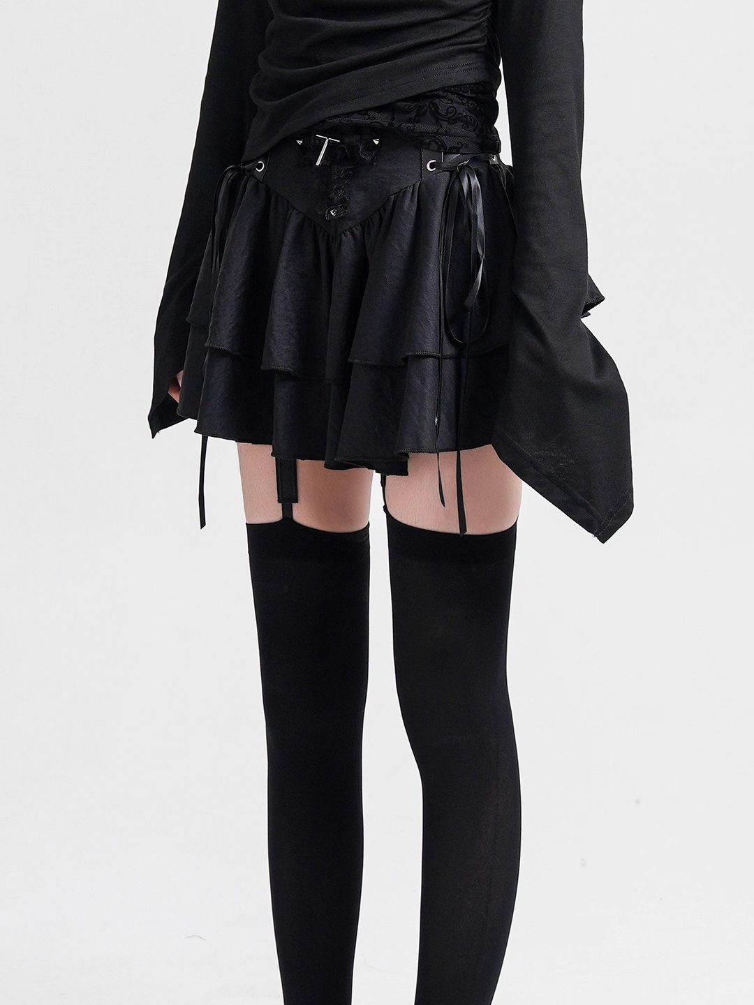 Black layered cake skirt with lace-up waist ties and tiered ruffle skirt.