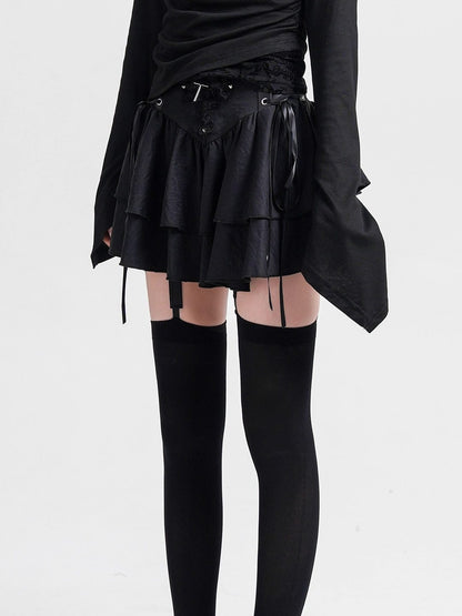 Black layered cake skirt with lace-up waist ties and tiered ruffle skirt.