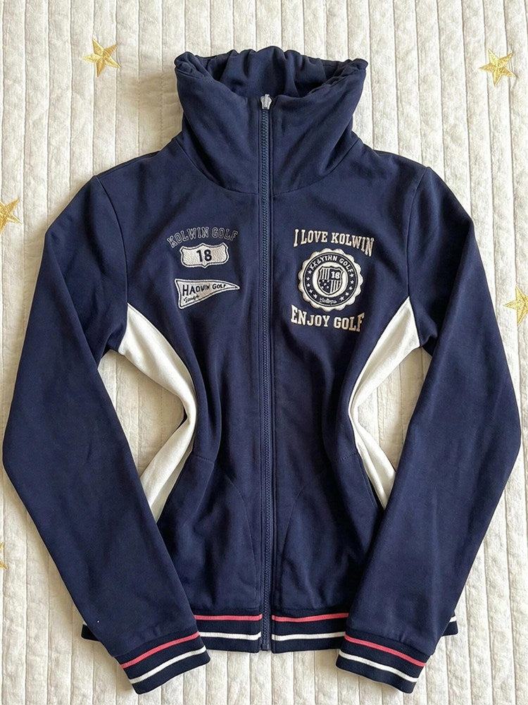 Navy stand-collar zip jacket with chest emblems and white side panels; ribbed striped cuffs