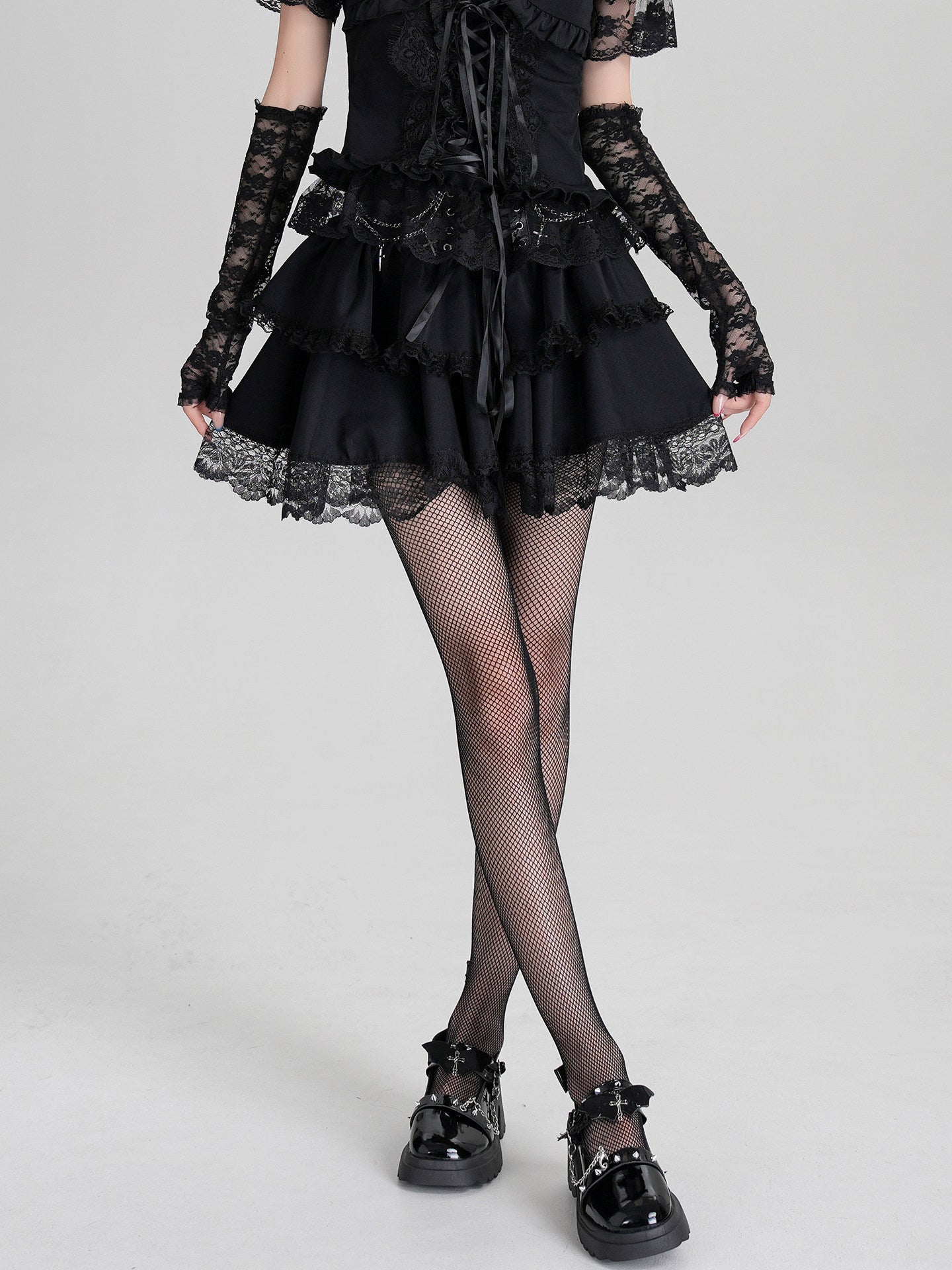 Black ruffle mini dress with off-shoulder lace sleeves and corset-lace front