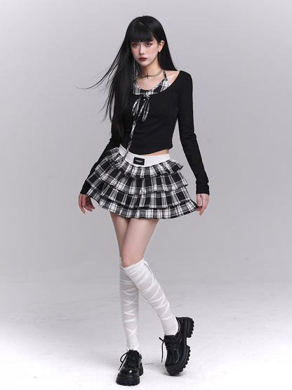 Black long-sleeve cropped top with plaid bow-tie neckline and tiered check skirt