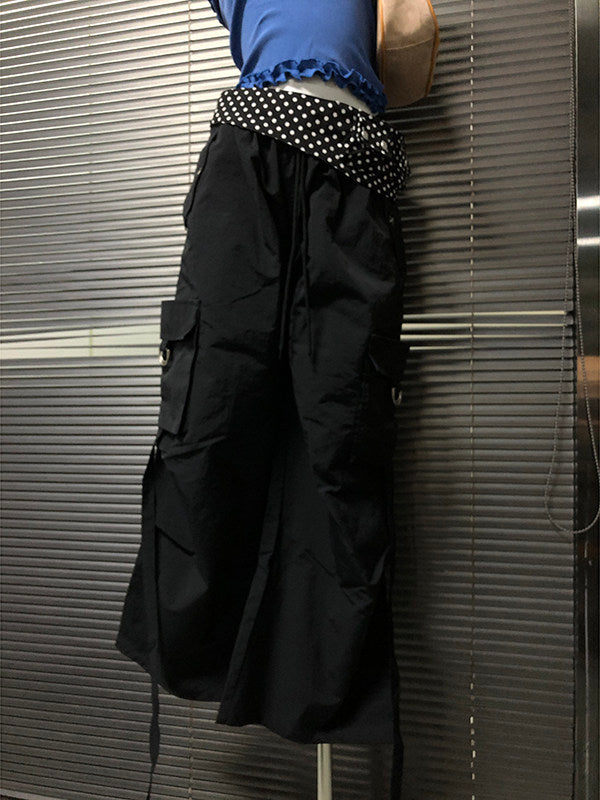 Black wide-leg pants detail: white polka-dot waistband band