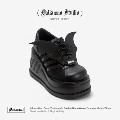 Black lace-up platform boots with winged side panels and chunky tread sole