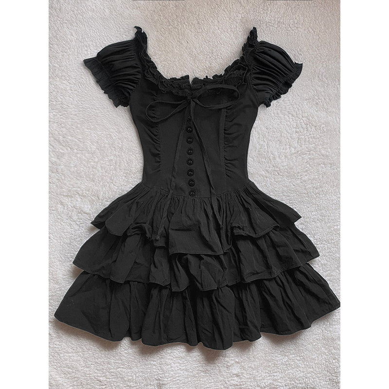 Black tiered cake dress with off-shoulder ruffles, center button placket, and bow tie