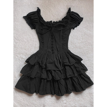Black tiered cake dress with off-shoulder ruffles, center button placket, and bow tie