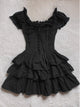 Black off-shoulder ruffle cake dress with corset-style button placket and tiered skirt