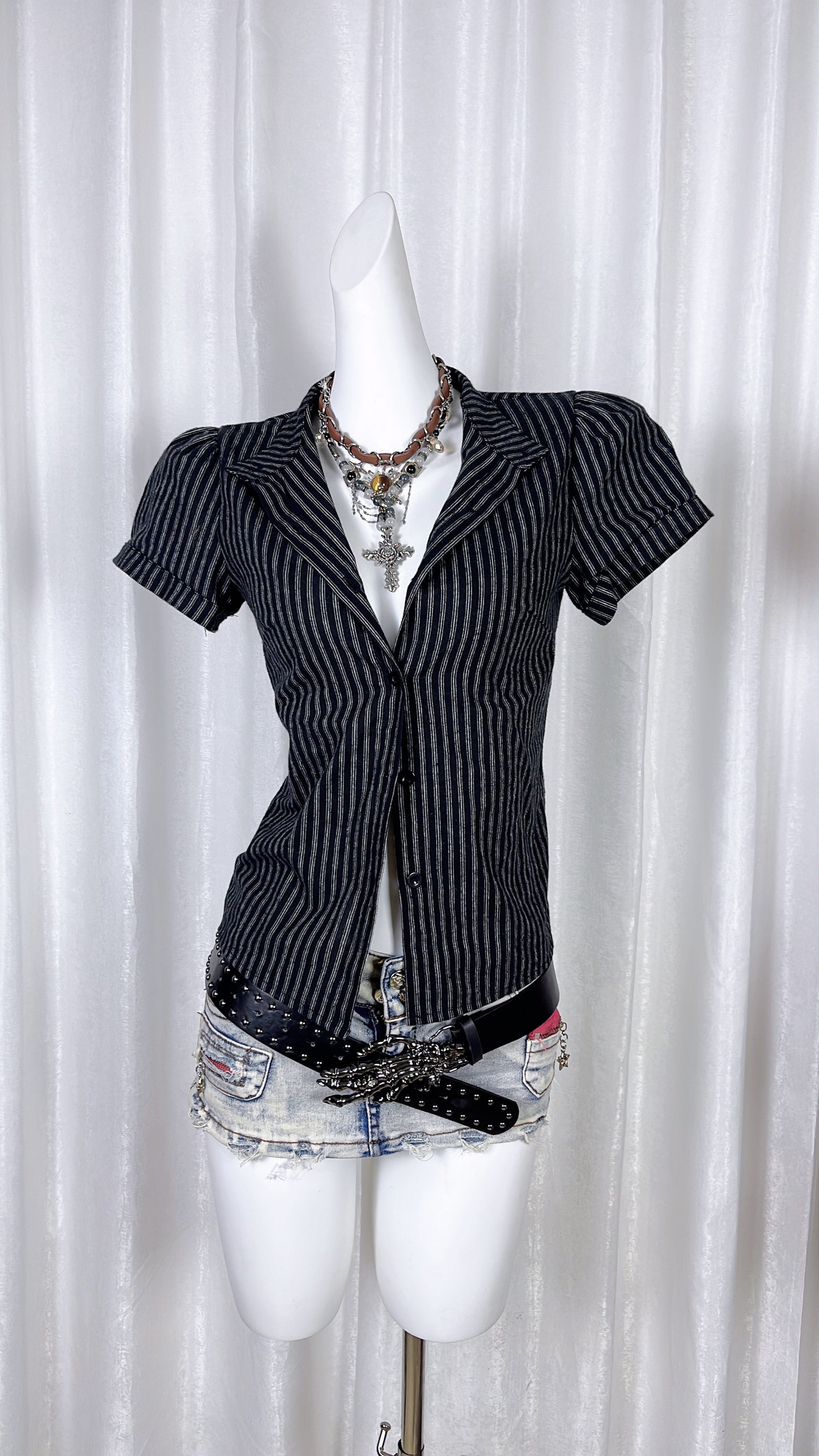 Navy pinstriped lapel shirt, short sleeves and buttoned front with V-neck