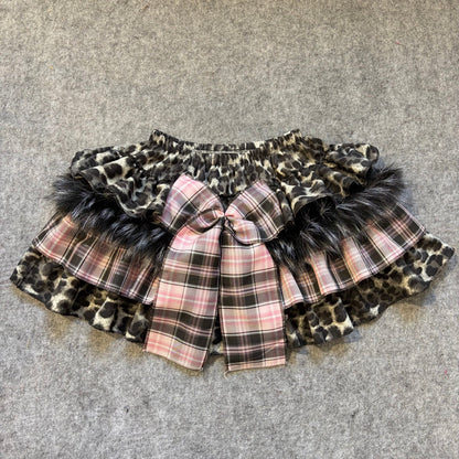 Puffy mini skirt with leopard print and pink plaid layers, faux fur trim and central bow