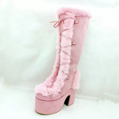 Pink platform ankle boots with lace-up straps, faux-fur cuff, and chunky heel