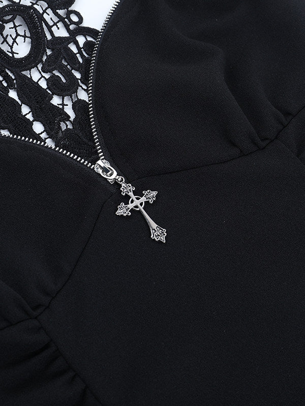 Black lace suspender vest close-up with silver zipper pull and cross charm