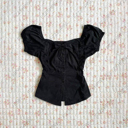 Black camisole with wide off-shoulder neckline, center buttons, gathered front, short length