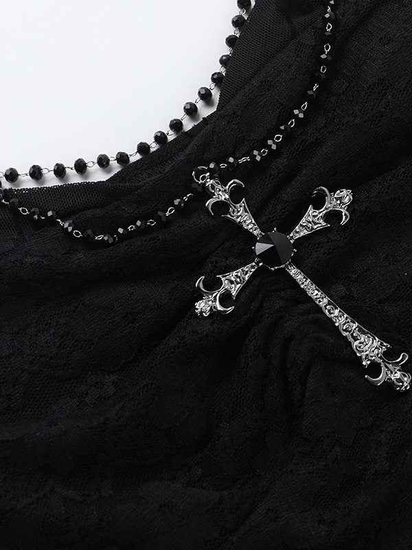Silver-tone chain and cross pendant on black lace suspender vest
