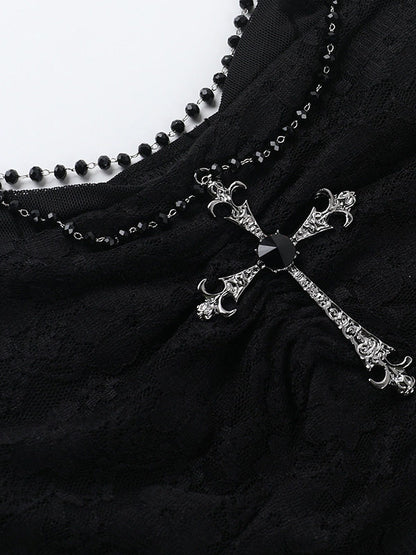 Silver-tone chain and cross pendant on black lace suspender vest
