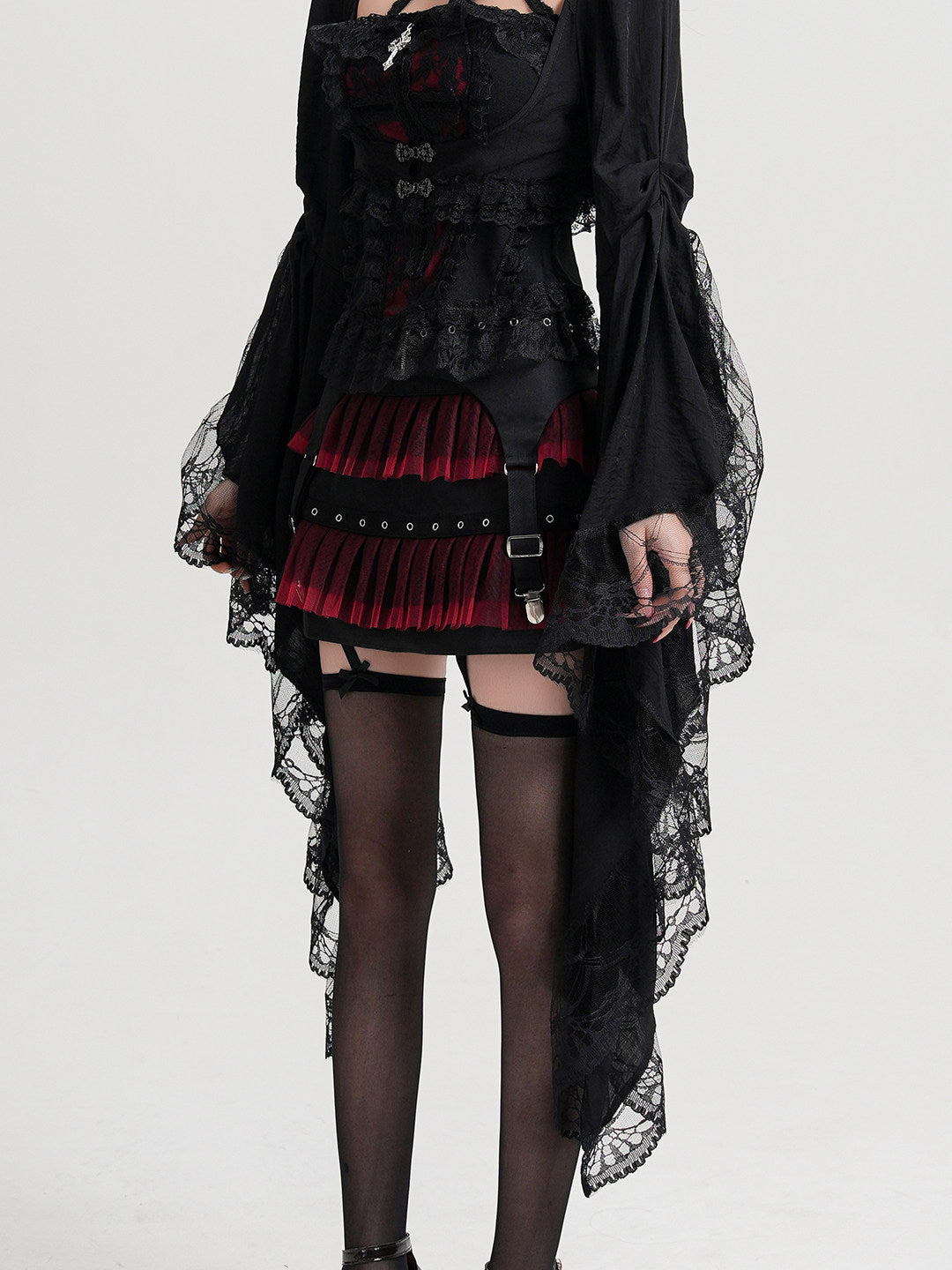 Black cropped lace coat with long flared sleeves and lace cuffs, open front.