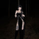 Black sleeveless cut-out dress with studded straps, V-neck, lace-up waist and thigh panels