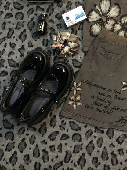 Khaki floral midi skirt with front pockets and script slogan near hem