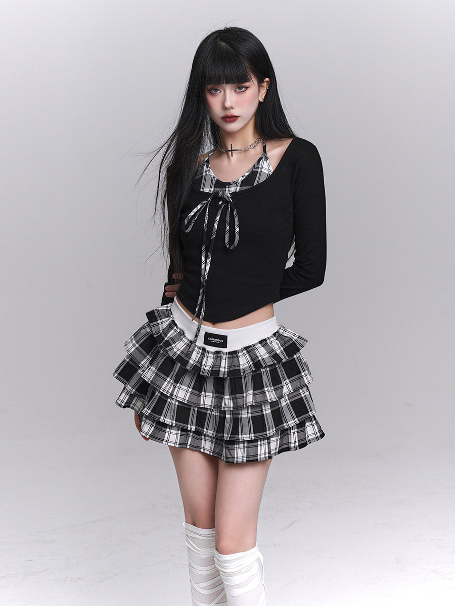 Black cropped long-sleeve top with plaid neckline and layered black-and-white check skirt