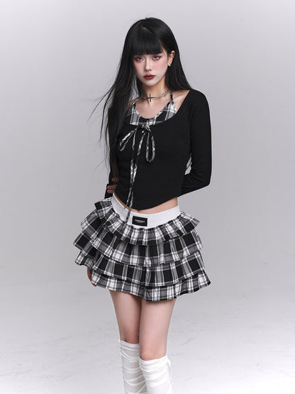Black cropped long-sleeve top with plaid neckline and layered black-and-white check skirt