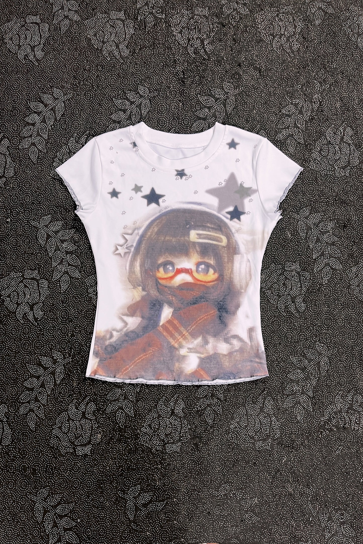 White graphic T-shirt with character portrait and gray star pattern