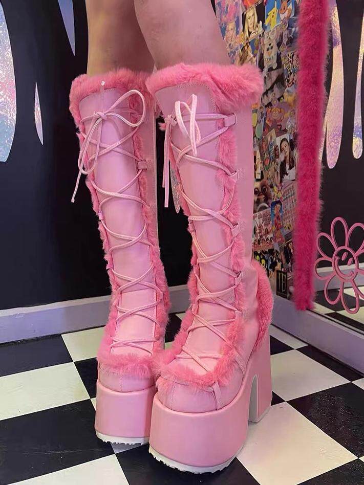 Pink platform ankle boots with lace-up front and thick faux-fur trim