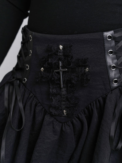 Black corset-style skirt panel with metal grommets, cross emblem, and lace trim