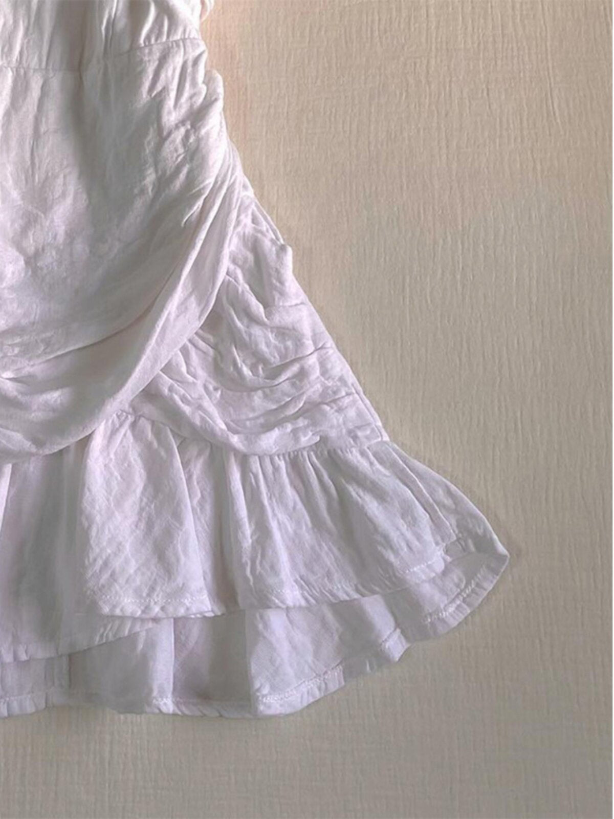White tiered ruffle skirt with pleated layers and gathered seam