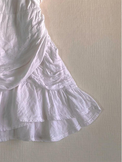 White tiered ruffle skirt with pleated layers and gathered seam