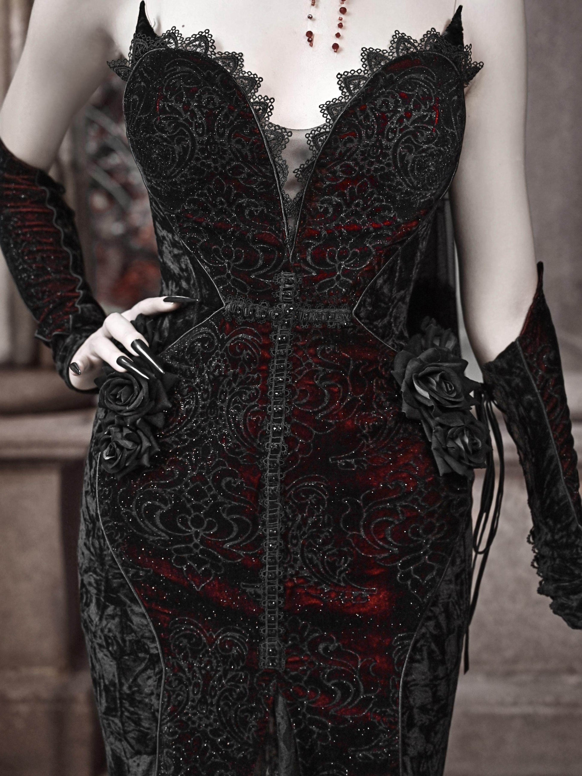 Black gothic corset dress bodice with lace trim and red accents, rose-like applique details.