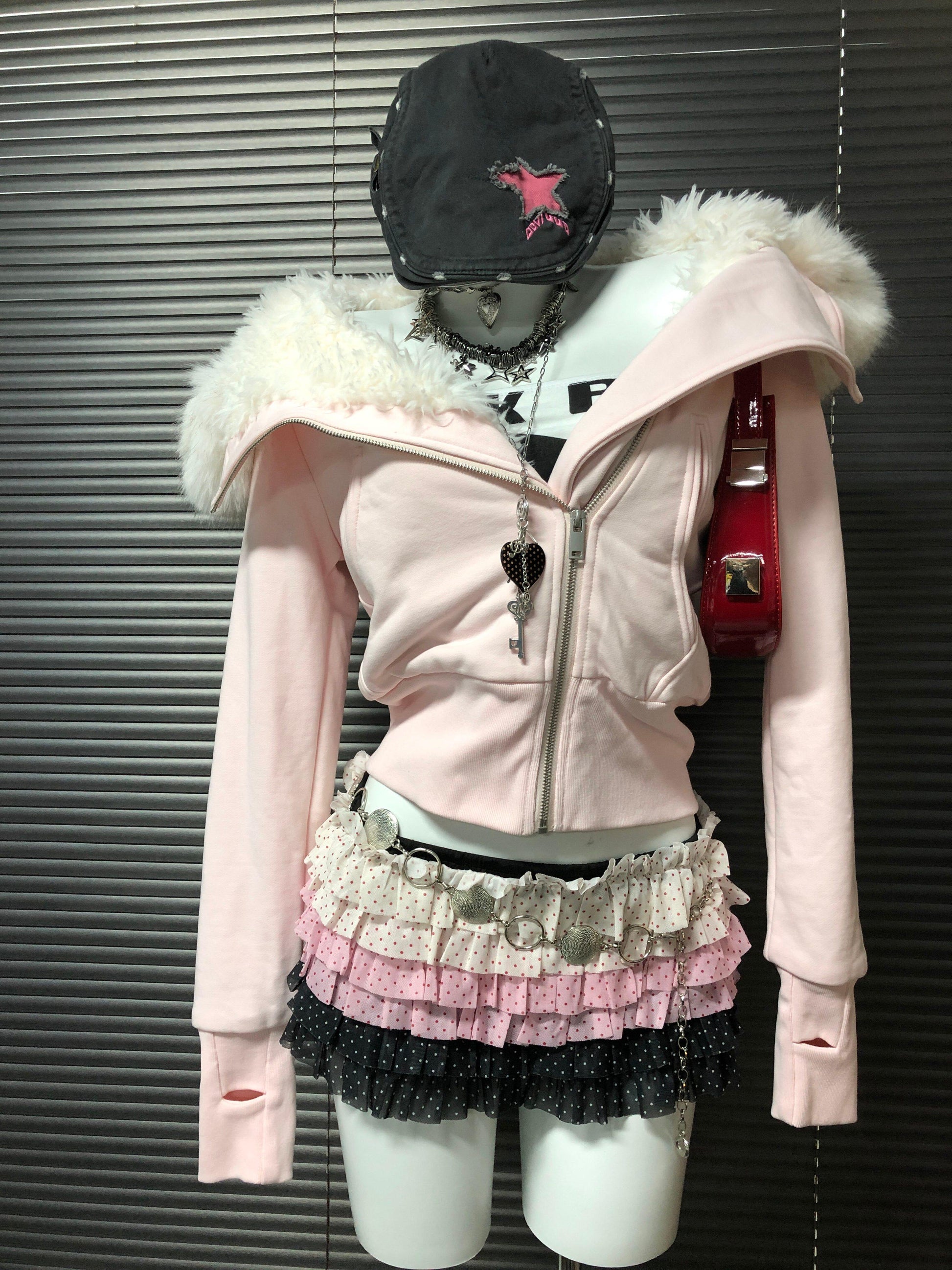 Pink hooded zip-up sweatshirt with white fur trim around hood and front zipper
