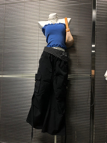 Black wide-leg cargo-style pants with white polka-dot waistband