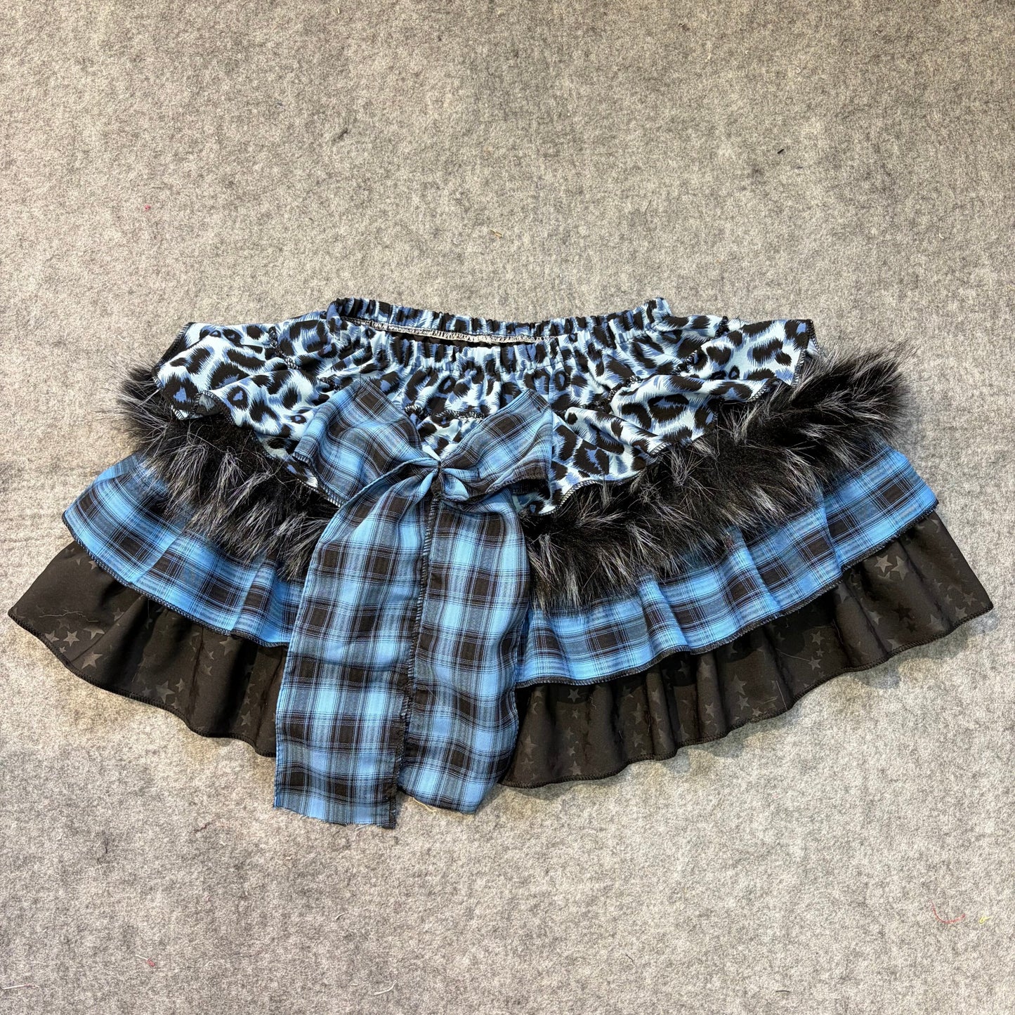 Blue plaid puffy mini skirt with leopard print ruffle, star-print panel, faux fur trim and bow