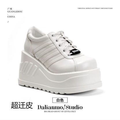 White lace-up platform shoes with low side panels, rounded toe, and thick tread sole