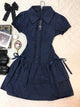 Dark blue lace patchwork dress with short puff sleeves, button front, and tiered skirt.