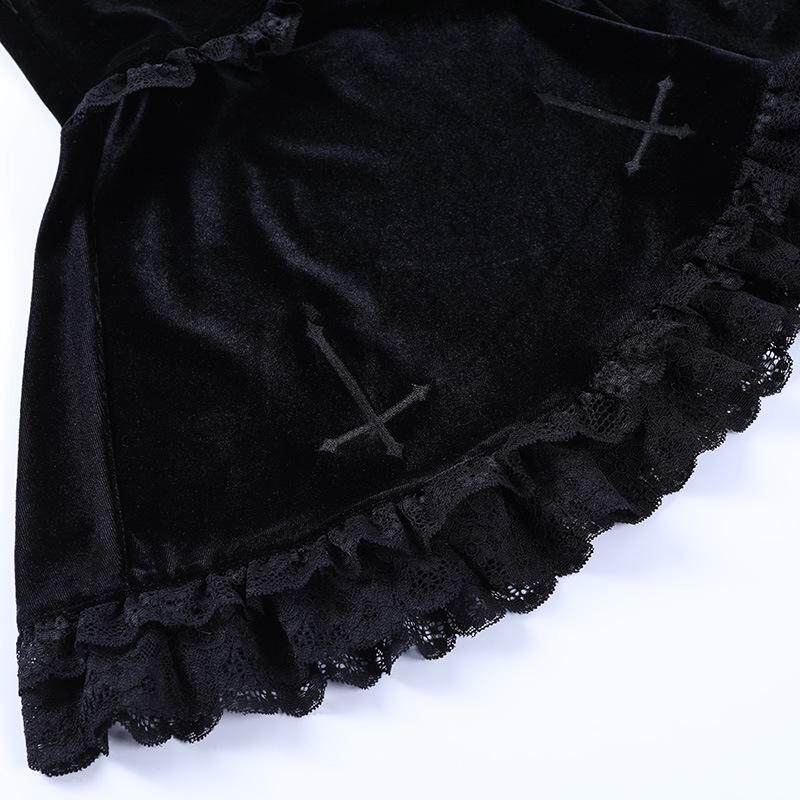 Black skirt close-up with cross embroidery and scalloped lace hem