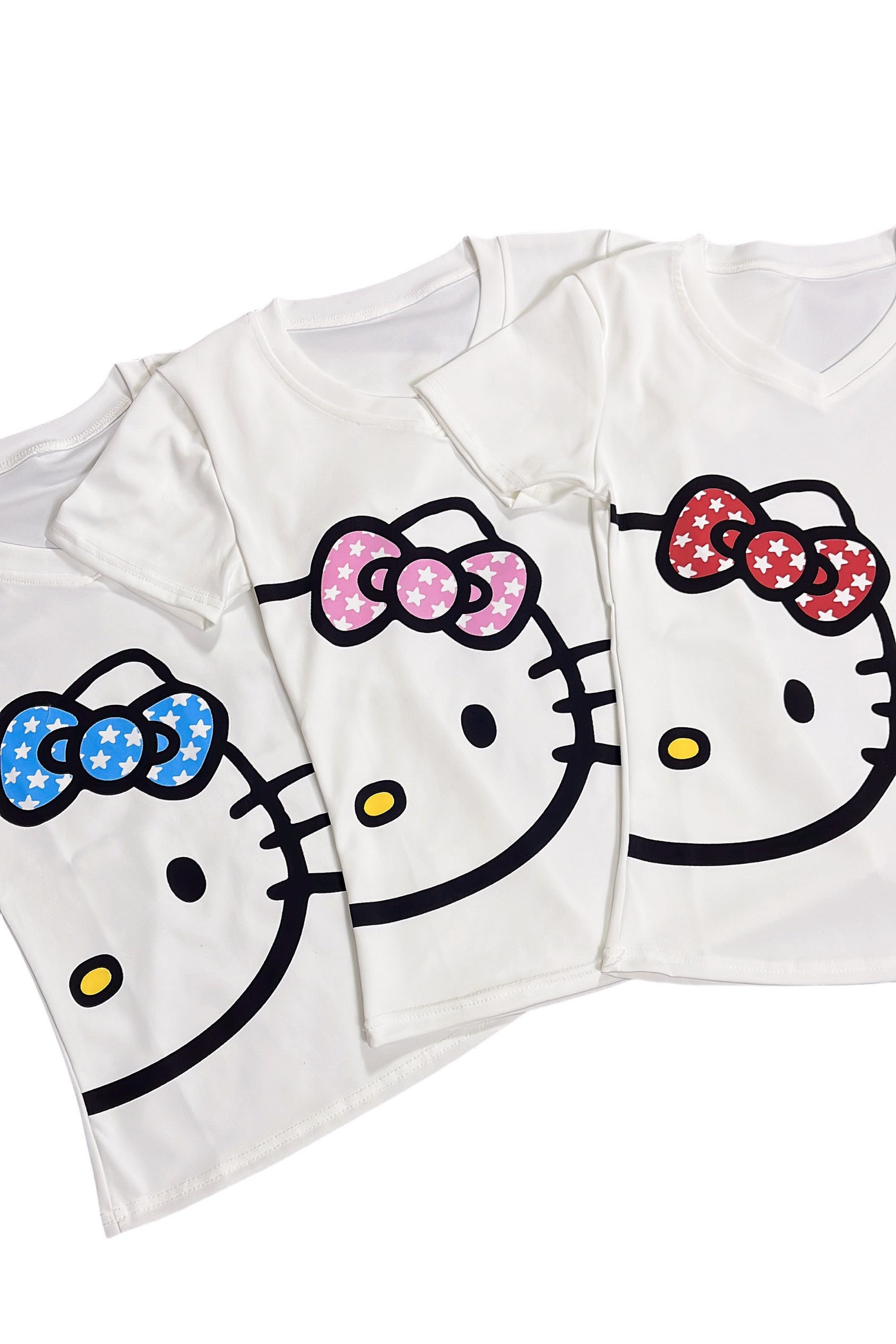 Stacked white v-neck T-shirts with kitty cat graphics and blue, pink, red bows