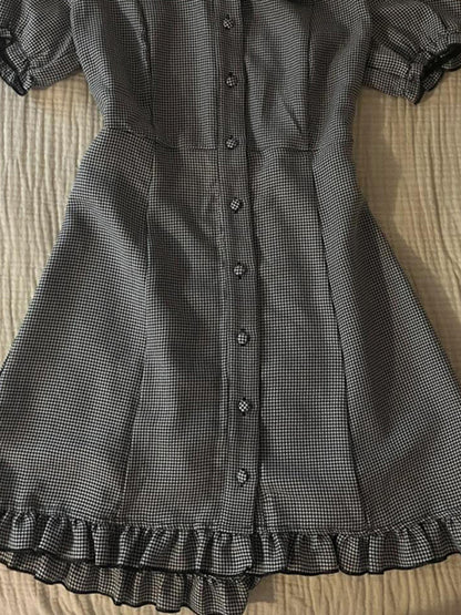 Plaid midi dress close-up: vertical button front and ruffled hem border
