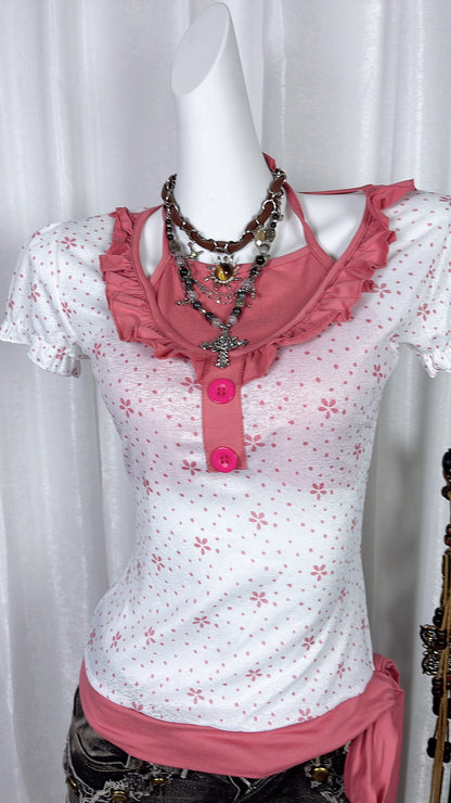 Pink flower print short-sleeve top with ruffled halter bib and round pink buttons