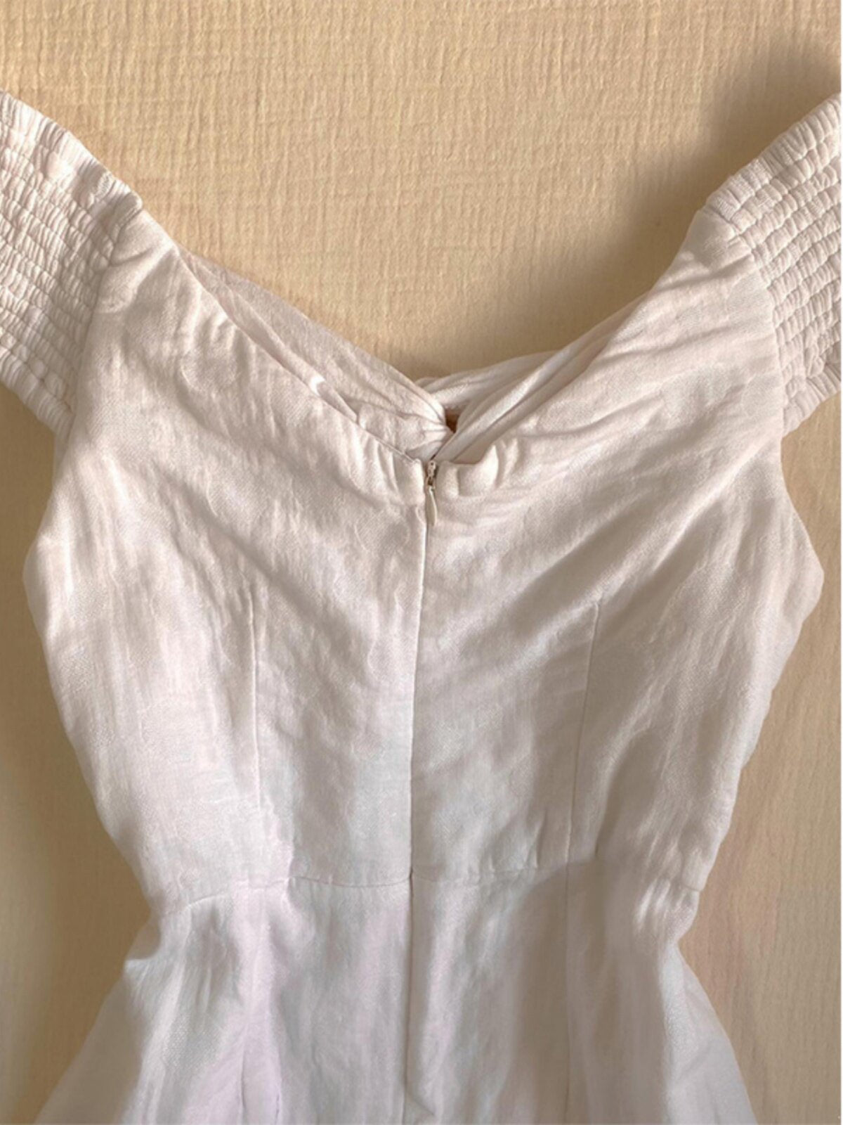 White one-shoulder short dress top with folded V neckline and ruched bodice