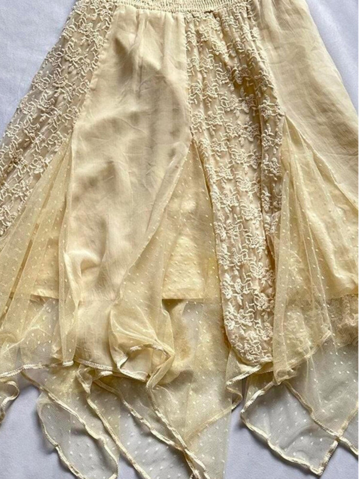 Yellow tulle skirt with lace insert panels and layered, uneven dangling hem