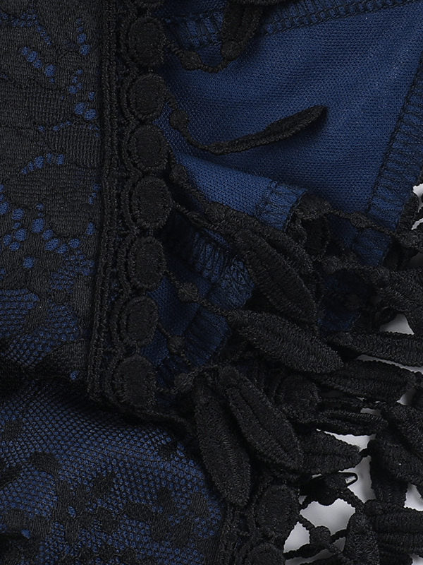 Jacquard fabric close-up with dark textured pattern and black tassel edging