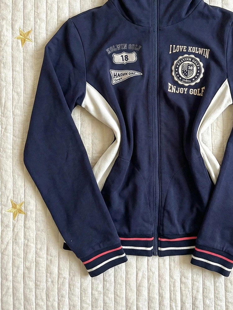 Navy stand-collar zip jacket close view with white side panels and striped ribbed cuffs